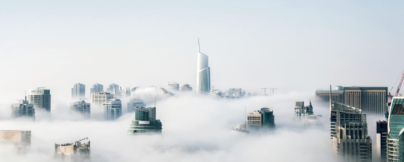 Skyline of Dubai with high-rise residential towers and ongoing real estate developments in the background