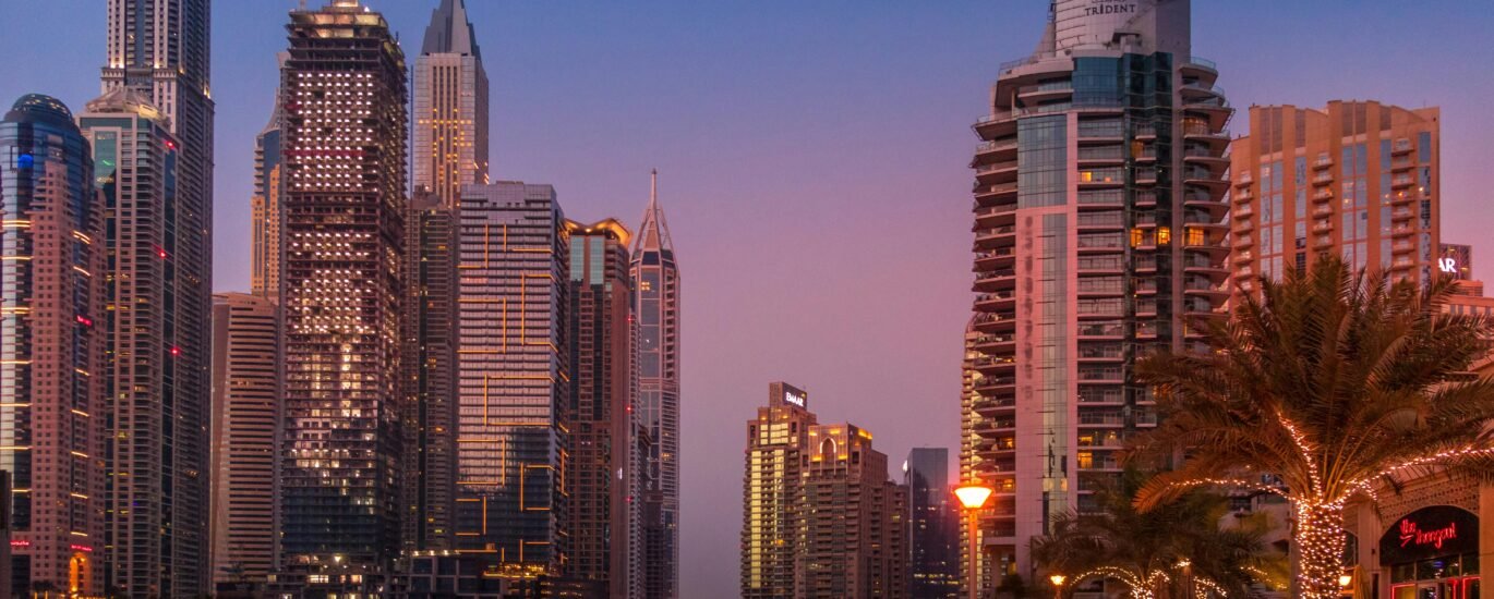 High-net-worth individuals arriving in Dubai with luxury skyline and wealth symbols