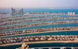 Aerial view of Dubai skyline showcasing luxury real estate and Palm Jumeirah - Dubai real estate news 2025