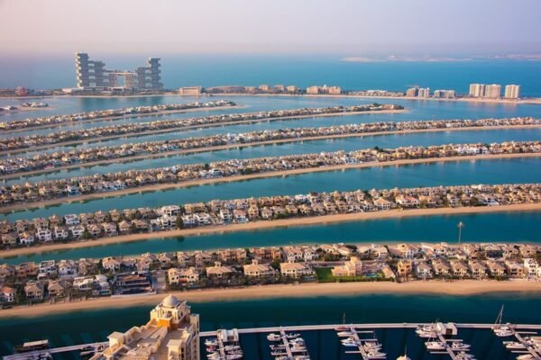 Aerial view of Dubai skyline showcasing luxury real estate and Palm Jumeirah - Dubai real estate news 2025